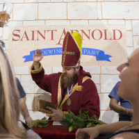 Saint Arnold himself blessing beers fresh of the tap. 